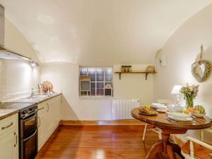 a kitchen with a table and a sink and a stove at 1 Bed in Crieff oc-87498 in Crieff +10 photos