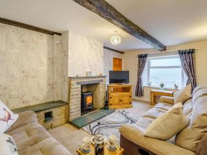 a living room with a couch and a fireplace at 3 Bed in Keswick oc-86613 in Threlkeld
