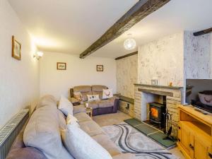 a living room with a couch and a fireplace at 3 Bed in Keswick oc-86613 in Threlkeld +4 photos