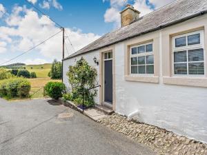 a white house with a door and a window at 1 Bed in Hawick oc-88731 in Hawick +9 photos