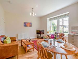 a living room with a table and a couch at 1 Bed in Hawick oc-88731 in Hawick