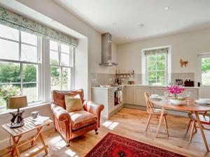 a living room with a table and a chair at 1 Bed in Hawick oc-88731 in Hawick