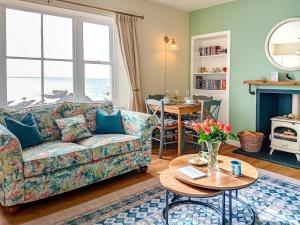 a living room with a couch and a table at 2 Bed in Anstruther oc-80648 in Pittenweem