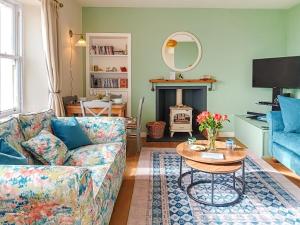 a living room with a couch and a table at 2 Bed in Anstruther oc-80648 in Pittenweem