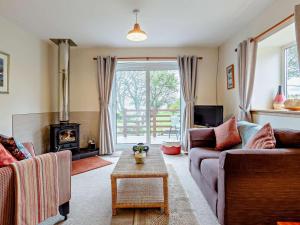 a living room with two couches and a fireplace at 1 Bed in Beauly oc-82778 in Beauly