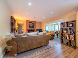 a living room with a large brown couch in a room at 2 Bed in Bonnybridge oc-95833 in Bonnybridge +10 photos