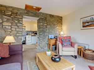 a living room with a stone wall at 1 Bed in Beauly oc-82778 in Beauly