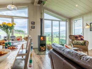 a living room with a couch and a fireplace at 2 Bed in Wigton oc-80563 in Caldbeck