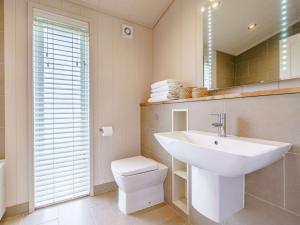 a bathroom with a sink and a toilet and a mirror at 2 Bed in Wigton oc-80563 in Caldbeck +24 photos