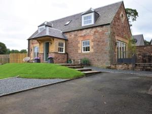 a brick house with a lawn in front of it at 2 Bed in West Linton oc-76383 in West Linton