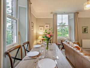a dining room with a table and a couch at 2 Bed in Ambleside oc-93287 in Near Sawrey +12 photos