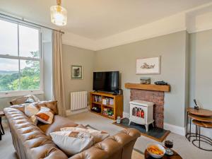 a living room with a couch and a fireplace at 2 Bed in Ambleside oc-93287 in Near Sawrey