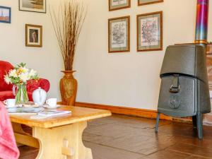 a living room with a fireplace and a table at 2 Bed in Appleby-in-westmorland oc-87537 in Long Marton