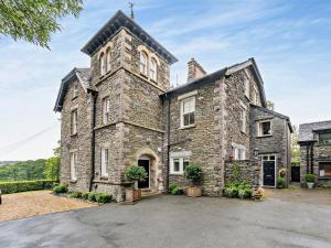 an old stone house with a tower at 2 Bed in Ambleside oc-93287 in Near Sawrey