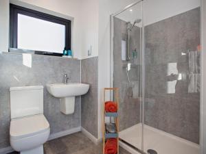 a bathroom with a toilet and a sink and a shower at 1 Bed in Ardgay oc-90470 in Bonar Bridge