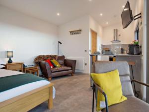 a bedroom with a bed and a couch and a kitchen at 1 Bed in Ardgay oc-90470 in Bonar Bridge +15 photos