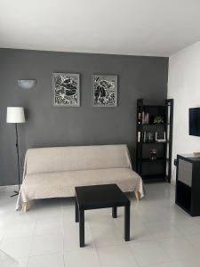 a bedroom with a bed with two pictures on the wall at Aguazul 120 in Tías