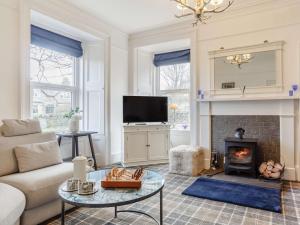 a living room with a couch and a fireplace at 4 Bed in Wick oc-91390 in Wick