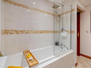 a bathroom with a tub and a glass shower at 1 Bed in Dollar oc-95872 in Powmill +10 photos