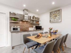 a kitchen and dining room with a wooden table and chairs at 4 Bed in Wick oc-91390 in Wick