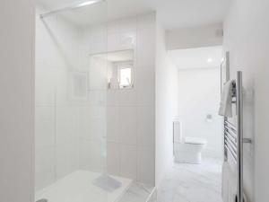 a white bathroom with a shower and a toilet at 4 Bed in Wick oc-91390 in Wick +39 photos