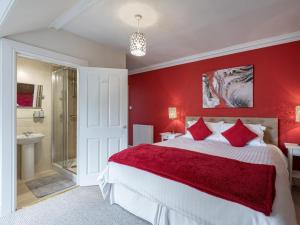 a red bedroom with a bed and a shower at 5 Bed in Melrose oc-79418 in Melrose
