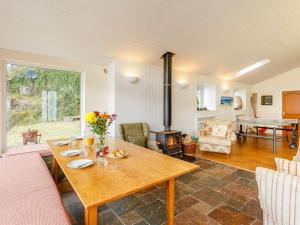 a living room with a wooden table and a fireplace at 6 Bed in Ullapool oc-ca259 in Ullapool