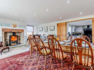 a dining room with a table and chairs and a fireplace at 5 Bed in Anstruther oc-83504 in Pittenweem