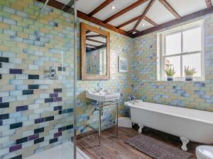 a bathroom with a tub and a sink at 5 Bed in Anstruther oc-83504 in Pittenweem +24 photos