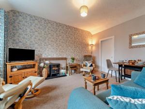 a living room with a couch and a tv at 2 Bed in Maybole oc-96012 in Maybole