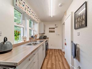 a kitchen with a sink and a counter at 2 Bed in Maybole oc-96012 in Maybole +9 photos
