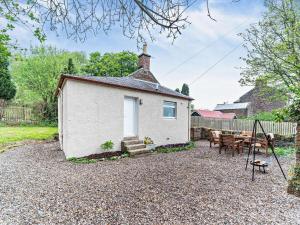 a cottage with a picnic table and a playground at 2 Bed in Maybole oc-96012 in Maybole