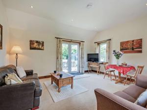 a living room with a couch and a table at 1 Bed in Castle Douglas oc-ca371 in Castle Douglas