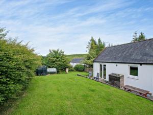 a house with a yard next to a building at 1 Bed in Castle Douglas oc-ca371 in Castle Douglas +2 photos