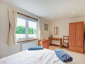 a bedroom with a bed and a window and a desk at 1 Bed in Castle Douglas oc-ca371 in Castle Douglas