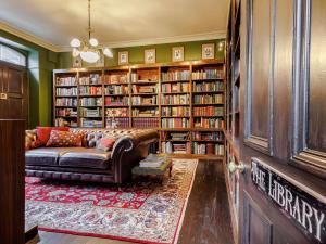 a living room with a couch and book shelves at 5 Bed in Dunkeld oc-90844 in Birnam