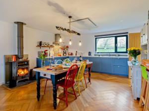 a kitchen with a table with chairs and a stove at 3 Bed in Pitlochry oc-ca207 in Struan