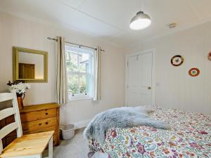 a bedroom with a bed and a window and a table at 1 Bed in Maybole oc-93562 in Maybole