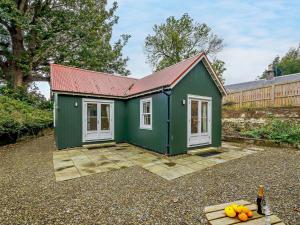 a green tiny house with a red roof at 1 Bed in Maybole oc-93562 in Maybole