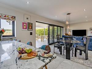 a kitchen and living room with a table with food on it at 3 Bed in Anstruther oc-96111 in Pittenweem