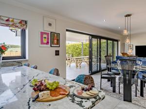 a kitchen and dining room with a table with food on it at 3 Bed in Anstruther oc-96111 in Pittenweem