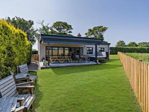 a house with a large yard with benches at 3 Bed in Anstruther oc-96111 in Pittenweem