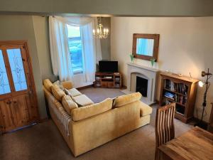a living room with a couch and a fireplace at 2 Bed in Millom oc-93608 in Millom