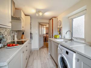 a kitchen with a sink and a dishwasher at 2 Bed in Millom oc-93608 in Millom +17 photos
