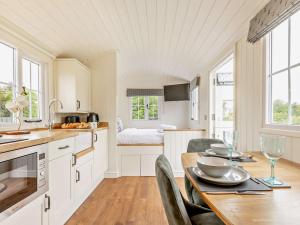 a kitchen and dining room with a table and chairs at 1 Bed in Forfar oc-92331 in Kingsmuir