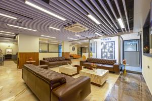 a lobby with couches and tables in a building at S by Z Hotels, Baani Square in Gurgaon