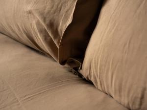 a close up of a pillow on a bed at Yarn - Arlo Deluxe Suite in Ballycastle