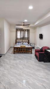 a large room with a bed and a couch at Golden Stay Inn in Kovakulam