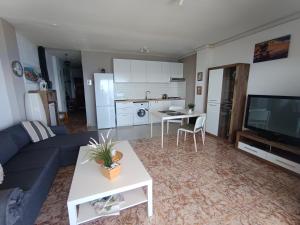 a living room with a blue couch and a table at Casa Barbarina in Almuñécar