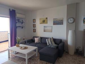 a living room with a couch and a table at Casa Barbarina in Almuñécar